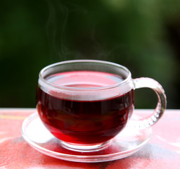 Cup of hot hibiscus red tea karkade