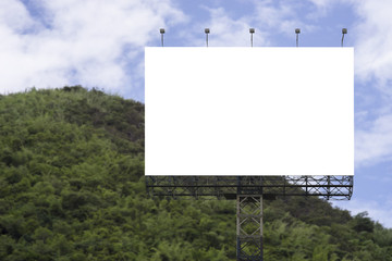 Blank big billboard against green mountain and blue sky background,for your advertising,put your own text here,isolate white on board