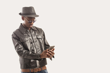 Portrait of young african american guy using a cell phone