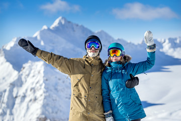 Fototapeta na wymiar Happy couple snowboarders in mountains
