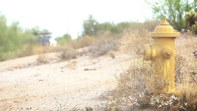 Yellow fire hydrant in Arizona desert close to a dead end road