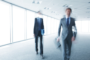 Blurry portrait of walking businessman