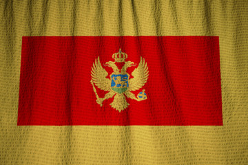 Closeup of Ruffled Montenegro Flag, Montenegro Flag Blowing in W