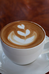 latte art coffee on wood table
