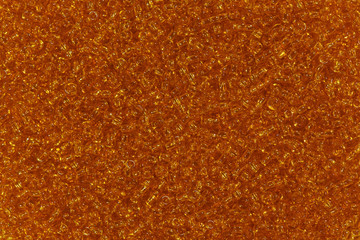 Clear dark orange glass beads.