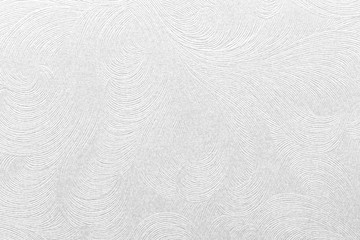 Embossed white paper with floral pattern.