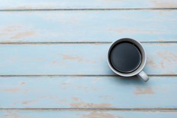 Cup of coffee on blue sky wooden floor.