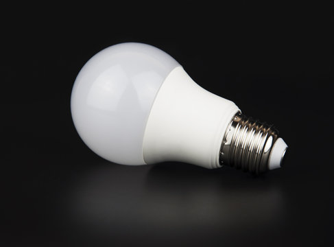 White LED bulb with reflection on black background
