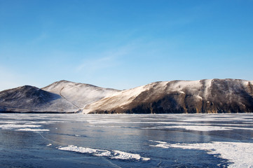 Winter. Ice on the surface of Lake Baikal. Ice thickness of about one meter. Cracks in the ice surface. Ice storm. Used toning of the photo.