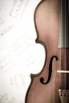 vintage classical violin on music sheet