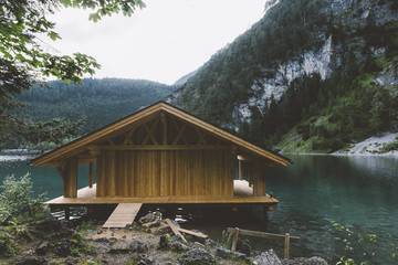 Wood house on lake with mountains and trees - 121650959