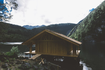 Wood house on lake with mountains and trees - 121651149