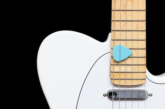 white electric guitar with blue picks, isolated on black