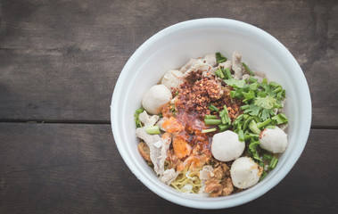 noodles in a styrofoam cup on wood background,selective focus.