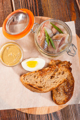 salted herring on board with toast and eggs