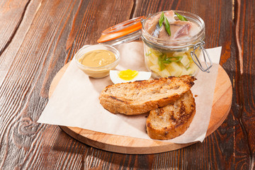 salted herring on board with toast and eggs