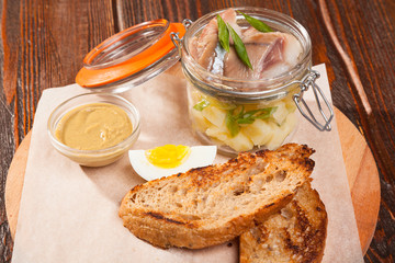 salted herring on board with toast and eggs