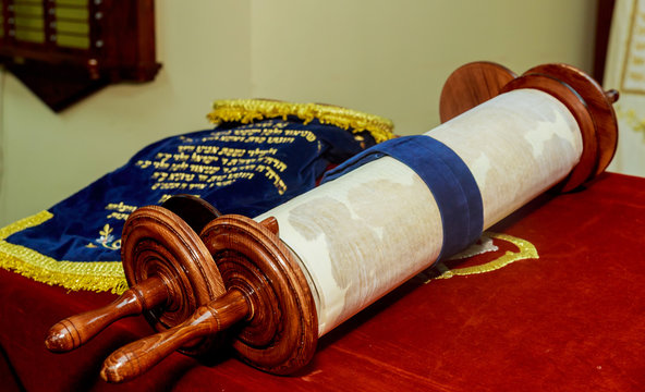 Hand of boy reading the Jewish Torah at Bar Mitzvah