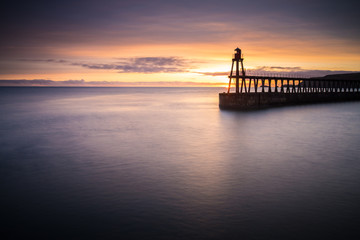 Whitby west pier sunrise reflections