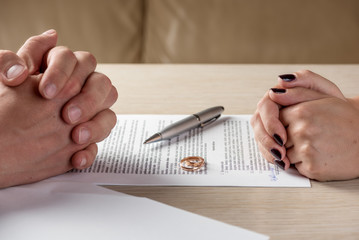Wife and husband signing divorce documents or premarital agreement - 121654723
