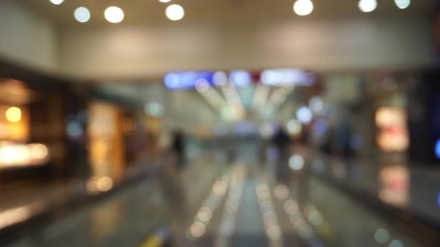 Blurred people walking in shopping mall bokeh background