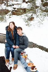 Young couple having fun outdoors in winter