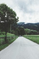 road in countryside in Austria with trees and mountains - 121658943
