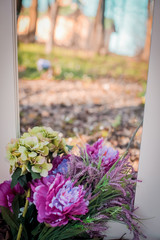Look from below at grey sky over blue and violet flowers