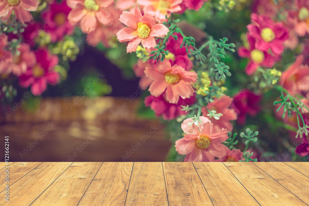 Wall mural wood floor with pink sweet flower background.