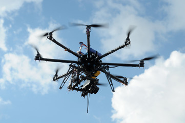 octocopter drone with digital camera in flight, used toning of the photo