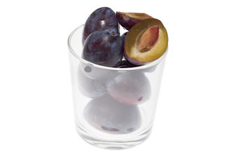 Plums in glass on white background