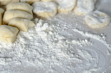 The dough rolled with circles, sprinkled flour. Making of pierog.