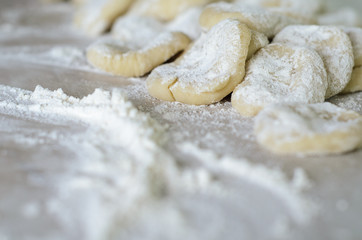 Fototapeta na wymiar The dough rolled with circles, sprinkled flour. Making of pierog.
