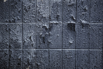 the old tile is covered with peeling paint