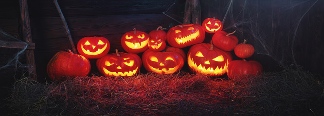 spooky halloween background. scary pumpkin with burning eyes and