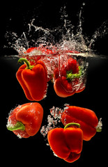 Image of Group of bell pepper falling in water with splash on black background printed on Printed Glass Splashbacks