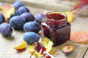 Sweet homemade plum jam and fresh autumn fruits