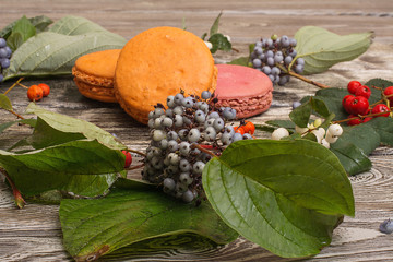 dessert macaroons with berries on a wooden table