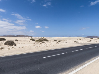 Endless street in the dessert in the last, warm light of the eve