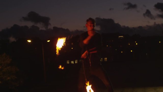 Male Artist Performing Fire Show Outdoors at Evening Time. Shot on RED Cinema Camera in 4K (UHD).