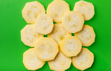 Zucchini sliced rings on the green chopping board