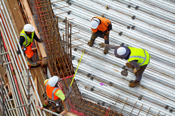 Civil engineer supervise roof construction workers work
