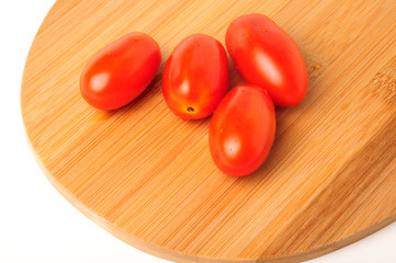 red cherry tomatoes on Bamboo cutting board