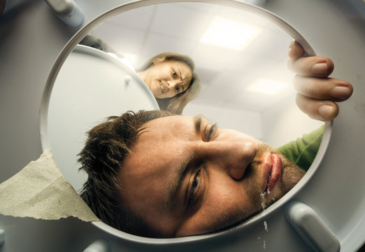 Man puking in the toilet bowl