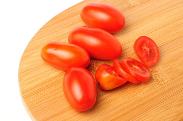 red cherry tomatoes on Bamboo cutting board