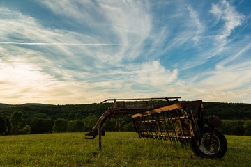 Farm landscape with hay rake