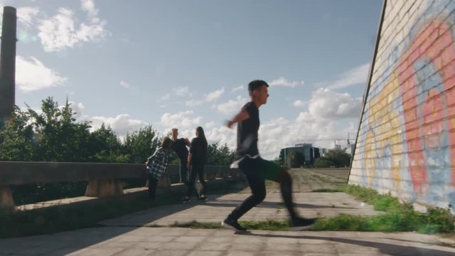 Young Male Freerunner Performing Tricks and Jumps Outdoors in Urban Environment. Shot on RED Cinema Camera in 4K (UHD).