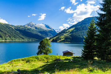 Fototapeta na wymiar Colorful summer morning on the Speicher Durlassboden lake. View of Richterspitze mountain range in the Austrian Alps. Austria, Europe.