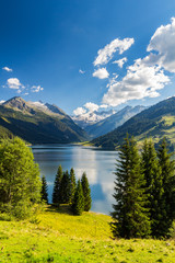 Colorful summer morning on the Speicher Durlassboden lake. View of Richterspitze mountain range in...