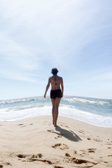 Fototapeta na wymiar woman walking on the beach